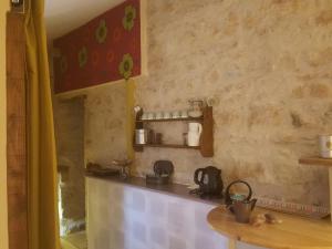 a kitchen with a counter and a table in a room at Chambre d'hôtes in Chiré-en-Montreuil