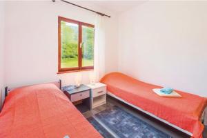 a bedroom with two beds and a window at Kuća Sonja in Vranje +29 photos