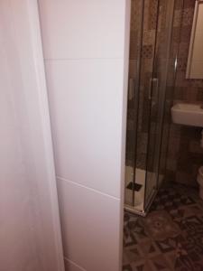 
a bathroom with a shower stall and a toilet at Hostal Sierpes in Seville

