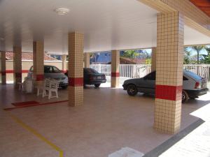 a parking lot with cars parked in a garage at Condomínio Pedra Coral in Ubatuba