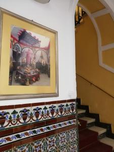 
a room with a painting on the wall and some stairs at Hostal Sierpes in Seville
