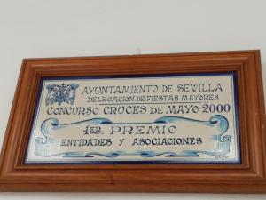 a picture of a sign in a wooden frame at Hostal Sierpes in Seville