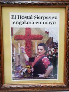 
a painting of a woman holding a bouquet of flowers at Hostal Sierpes in Seville
