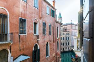 a view of a canal in a city with buildings at Luxury Venetian Rooms in Venice