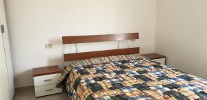 a bedroom with a bed with a quilt on it at Ladybug Apartment in Poggibonsi