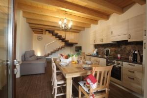 a kitchen and dining room with a table and a staircase at AGRITURISMO CORTE FONTANA in Salò