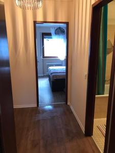 a hallway with a room with a bed and a mirror at Central-Apartment-Adria in Saarbrücken