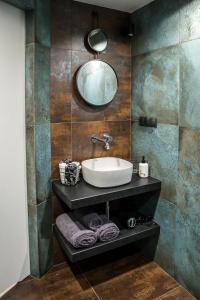 a bathroom with a sink and a mirror at Augustiańska in Kraków