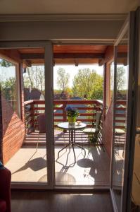 a screened in porch with a table and chairs at Sunshine Apartment Velence in Velence