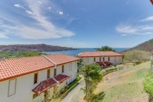 a view of two buildings with a lake in the background at Villas @ Villa Sol in Guanacaste