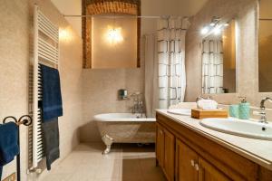 a bathroom with a tub and a sink and a bath tub at Castello di Montonate in Mornago