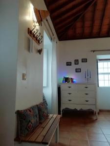 a living room with a bench and a dresser at Casa do Norte - Santa Maria in Norte