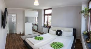 a bedroom with a large white bed with green pillows at DD Apartments in Dresden