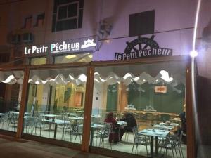 un restaurante con mesas y sillas en su interior en Résidence Al Osra, en Agadir