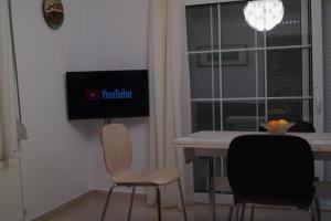 A television and/or entertainment centre at Τhe Sunny Apartments