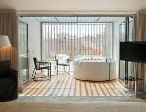 a living room filled with furniture and a large window at Inspira Liberdade Boutique Hotel in Lisbon