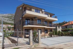 a building with a fence in front of it at Luxury Apartments Taša in Trebinje