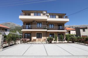 a house with a large driveway in front of it at Luxury Apartments Taša in Trebinje