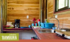 a kitchen with a sink and a counter top at Bambura Hermosa villas in Uvita +98 photos