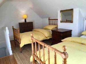 a bedroom with two beds and a mirror at Cathedral View in Salisbury