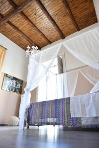 a bedroom with a bed with a canopy and a window at B&B A due passi in Caserta