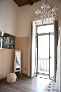 a room with a door open to a balcony at B&B A due passi in Caserta