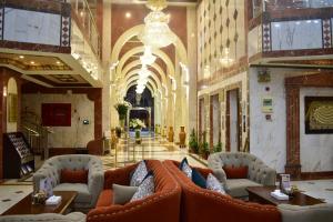 a lobby with couches and tables in a building at Canary Beach Hotel in Yanbu