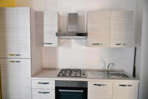 a small kitchen with a stove and a sink at B&B A due passi in Caserta