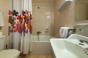 a bathroom with a sink and a toilet and a shower curtain at Hotel Mar i Sol in Calella +34 photos