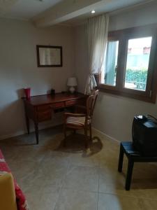 a room with a desk and a chair and a window at da Fabio in Castelfranco Veneto