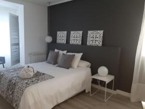 a bedroom with a white bed and a white table at La parada de Conde Aranda in Zaragoza