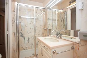 a bathroom with a shower and a sink and a mirror at Appartement Luxueux 150m2 - Cannes in Cannes +29 photos