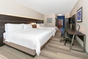 a hotel room with two beds and a desk at Holiday Inn Express Hotel & Suites Seaside Convention Center, an IHG Hotel in Seaside