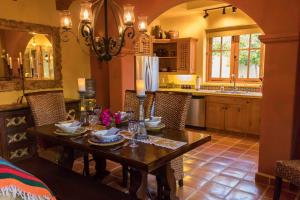 a kitchen with a wooden table and a dining room at Casa Linda in Loreto