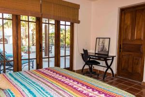 a bedroom with a bed and a desk with a table at Casa Vista del Mar in Loreto