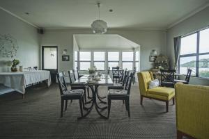 a dining room with a table and chairs at Lands End in Bluff