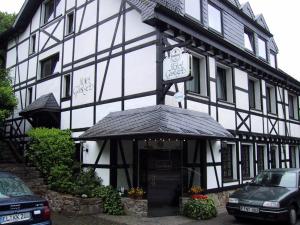 a black and white building with a clock on it at Hotel Gastgeb in Essen