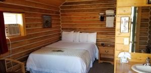 a bedroom with a bed in a log cabin at Alpine Lodge in Red Lodge +64 photos