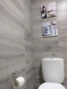 a bathroom with a toilet and a picture on the wall at V4 in Horta +20 photos