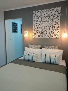 a bedroom with a large bed with white pillows at V4 in Horta
