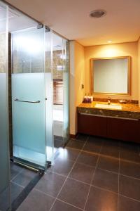 a bathroom with a shower and a sink at Sobaeksan Punggi Spa Resort in Yeongju