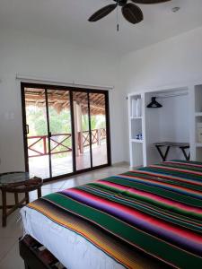 a bedroom with a bed and a large window at CASA TORTUGA, Soliman Bay in Tulum +57 photos