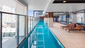 a swimming pool on the roof of a building at Avani Adelaide Residences in Adelaide