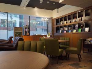 a restaurant with a table and chairs and a counter at Hotel WBF Sapporo Chuo in Sapporo