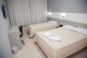 Postel nebo postele na pokoji v ubytování Apucarana Palace Hotel + 35 fotografií
