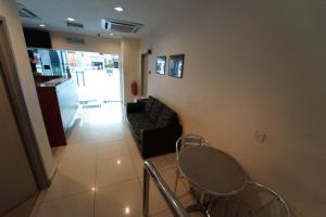 a living room with a table and chairs and a couch at Hotel A-One in Kuala Lumpur