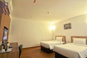 Greencity Hotel tesisinde bir odada yatak veya yataklar