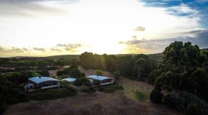 an aerial view of two houses on a hill with trees at Hilltop Studios in Margaret River Town