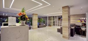 a lobby with flowers and furniture in a building at For You Hotel in Nha Trang