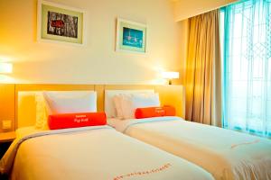 Voodi või voodid majutusasutuse HARRIS Hotel & Conventions Malang toas